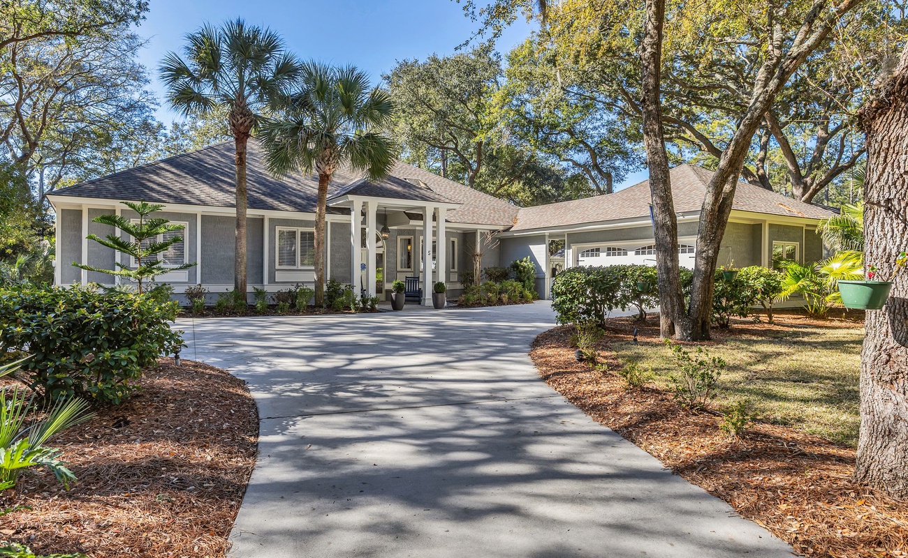 This elegant home sits beautifully among mature trees and tropical landscaping, offering a peaceful retreat in a natural setting.