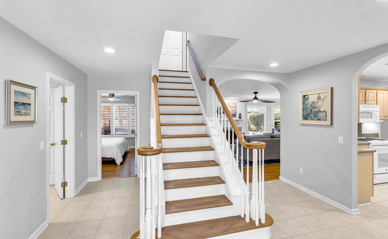 Step into your bright, open foyer where elegant stairs lead to your private retreat upstairs.