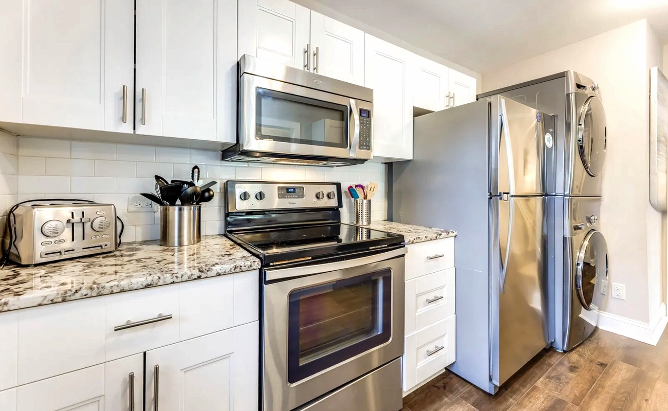 Your fully equipped modern kitchen features granite countertops, stainless steel appliances, and everything you need to create memorable meals during your stay.