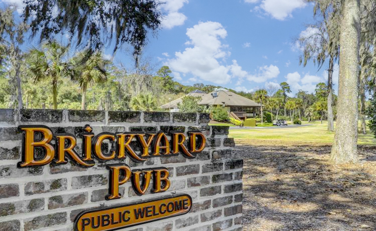 The welcoming entrance to Brickyard Pub sets the scene for your Florida getaway, surrounded by lush tropical landscaping and Southern charm.