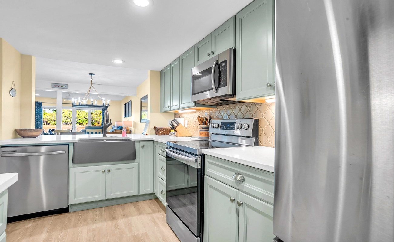 Your spacious kitchen awaits with modern appliances, beautiful sage cabinetry, and everything needed to create memorable meals during your stay.