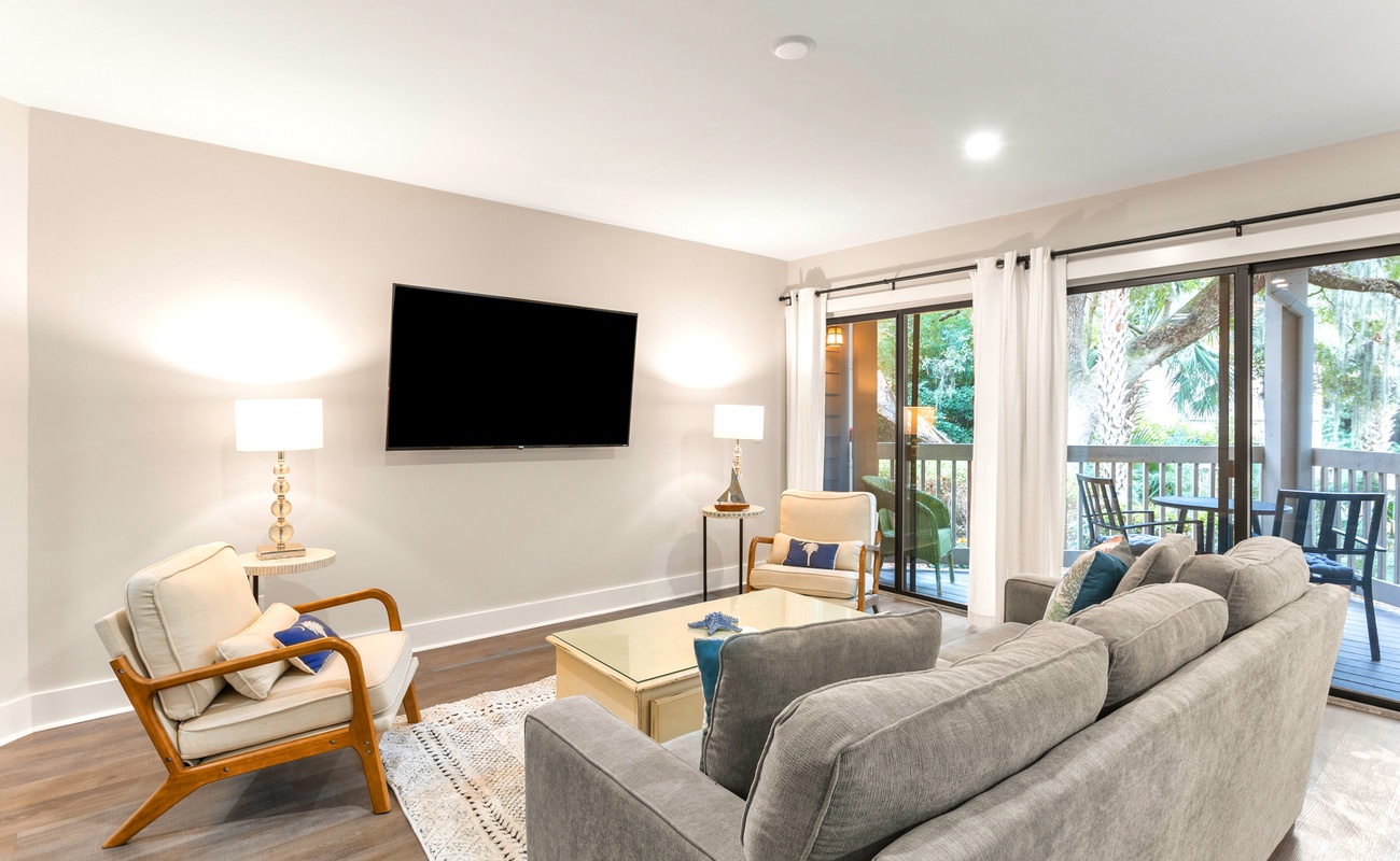 Settle into this elegant living room where plush gray sofas and stylish chairs create the perfect spot for relaxation.