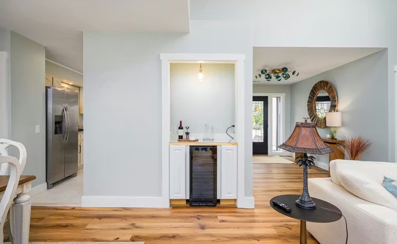 Your stylish open-concept living space flows seamlessly from lounge to kitchen, featuring warm hardwood floors and thoughtful details throughout.