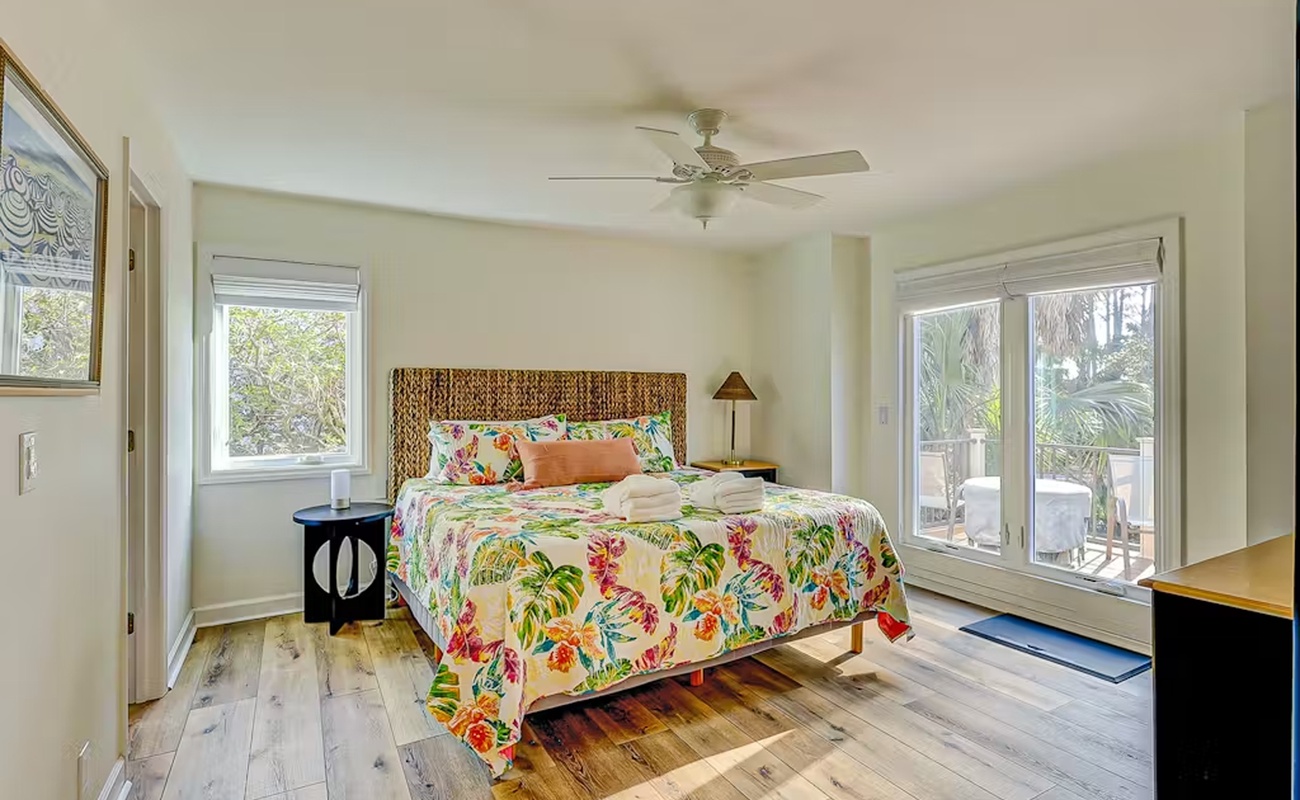 Wake up in your tropical retreat with vibrant florals and gentle breezes from the ceiling fan cooling your mornings.