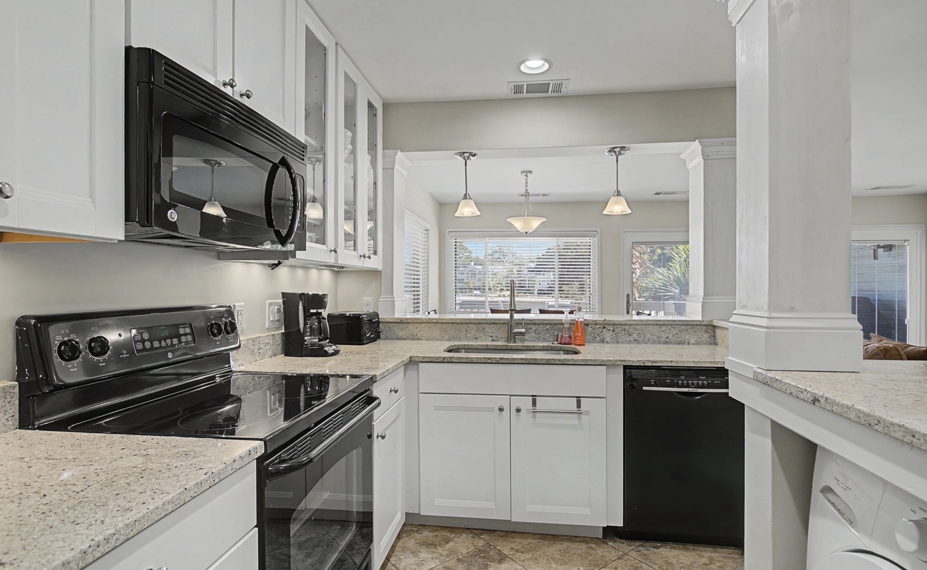 Whip up your favorite meals in this bright, fully-equipped kitchen with granite counters and modern appliances.