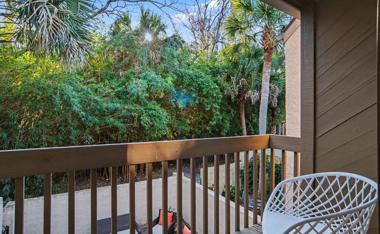 Step onto your private balcony and breathe in the tropical air surrounded by lush palms and greenery.