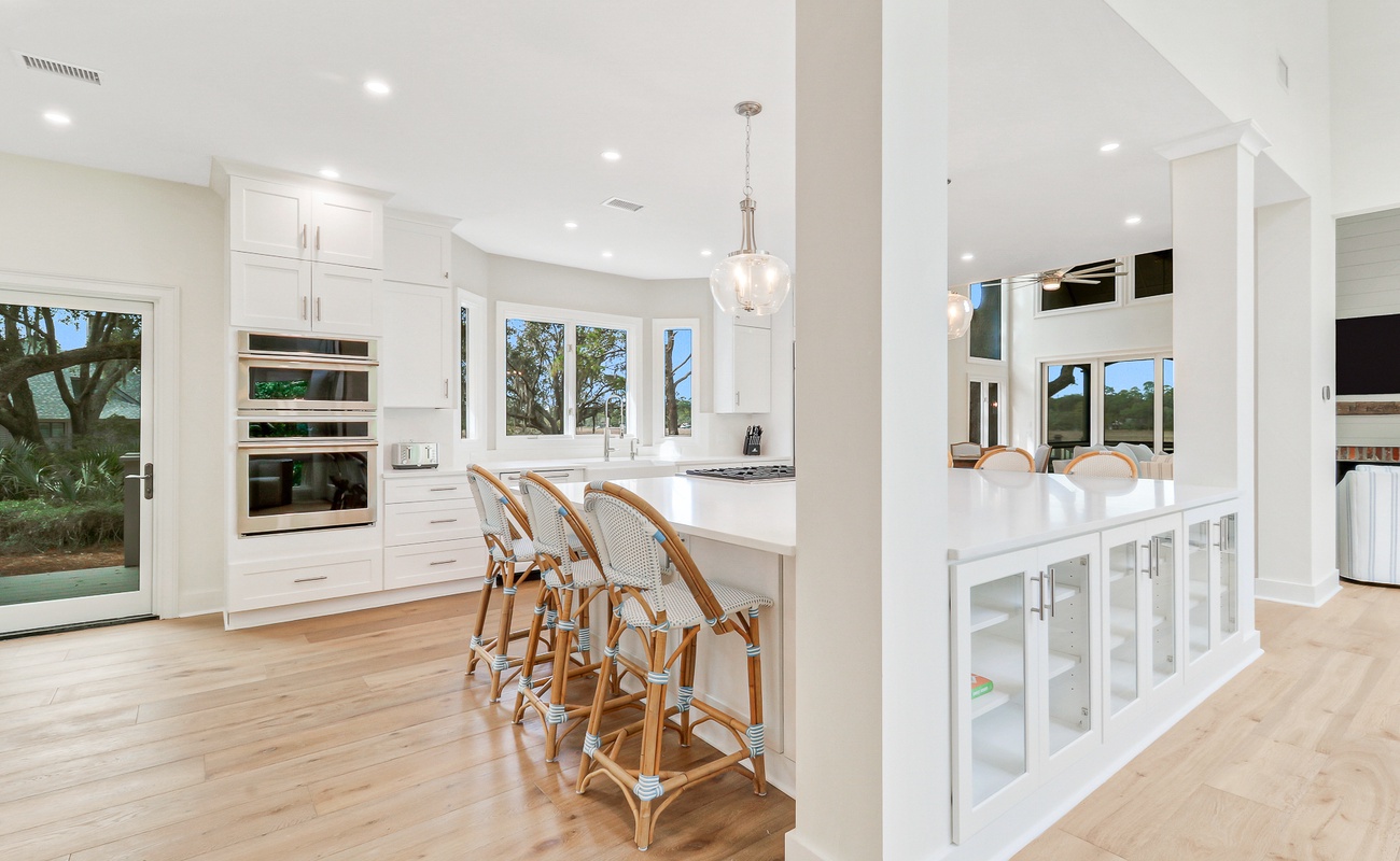 Your dream kitchen awaits with pristine white counters, stylish bar seating, and gleaming appliances where you'll create memorable meals.