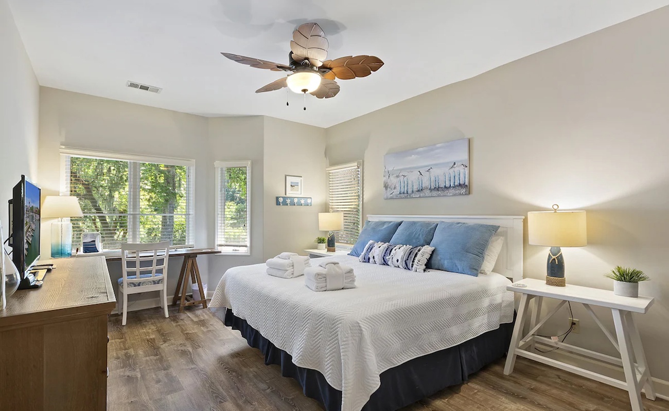 Relax in your peaceful bedroom with soft linens, natural light, and charming coastal touches for the perfect retreat.