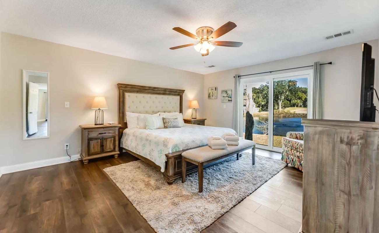 Wake up to serene water views from your beautifully appointed bedroom, complete with plush linens and elegant furnishings for ultimate comfort.