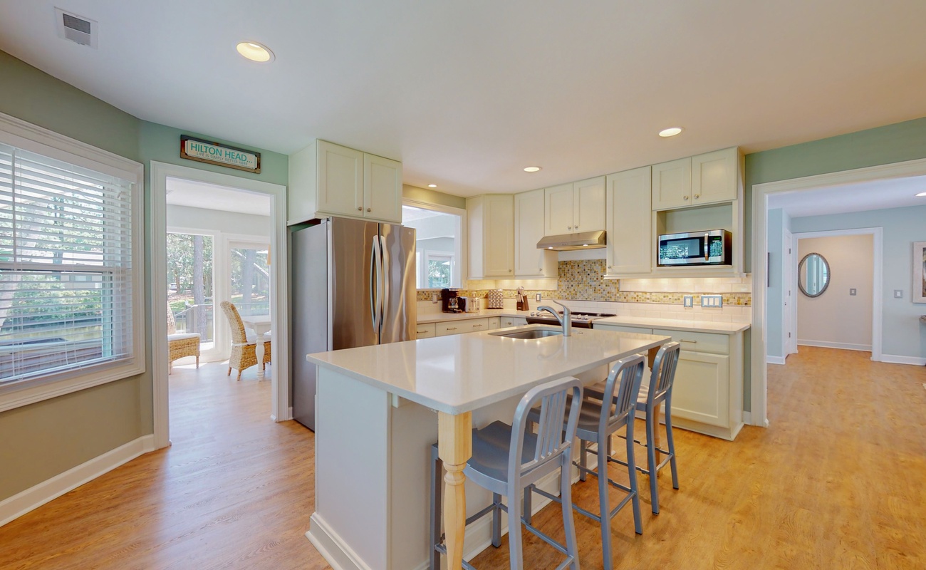 Your spacious kitchen awaits with gleaming countertops, modern appliances, and a welcoming island perfect for morning coffee or evening conversations.