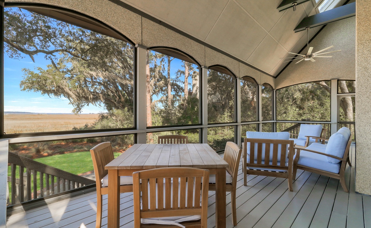 Sip your morning coffee on this screened porch while gazing across peaceful marshlands and towering oaks draped in Spanish moss.