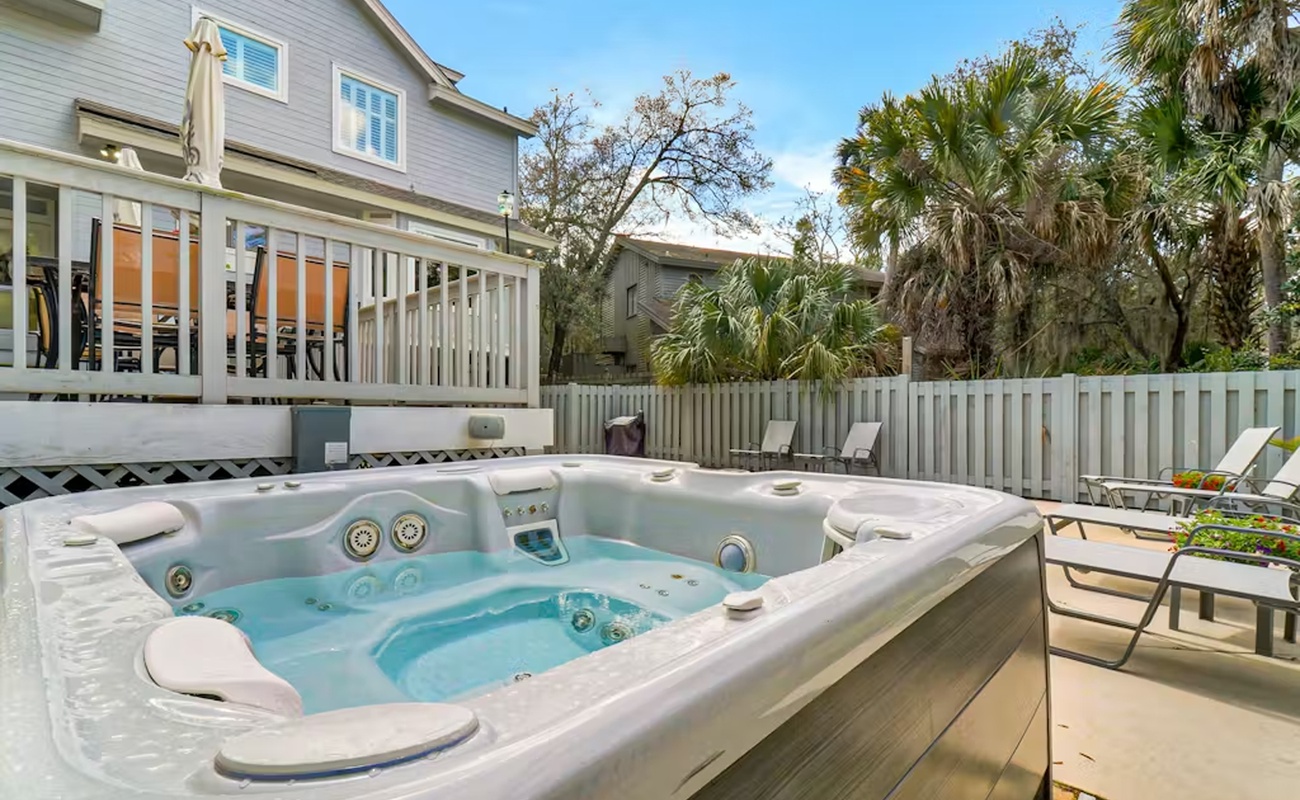 Soak your worries away in this private hot tub, surrounded by tropical palms and your own peaceful backyard oasis.