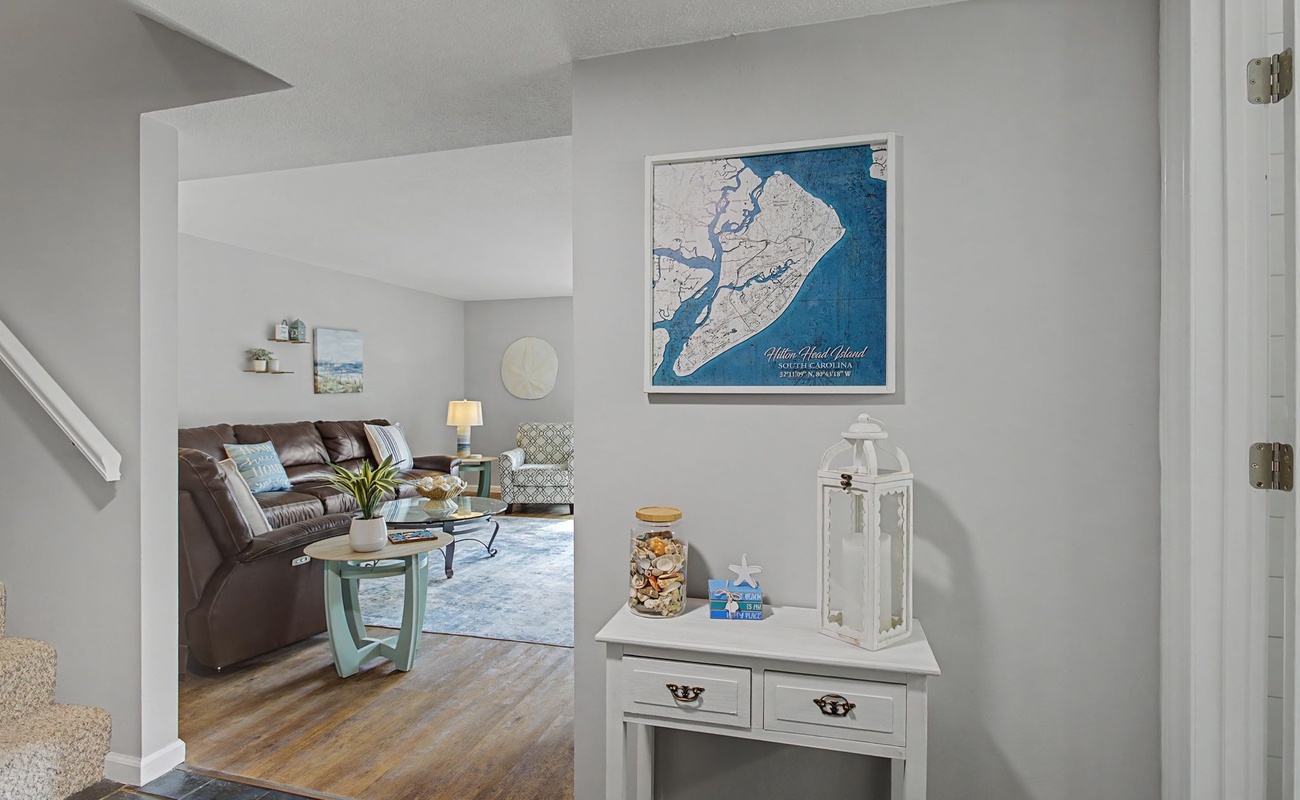 Step into your coastal retreat where nautical charm meets modern comfort in this inviting living space.