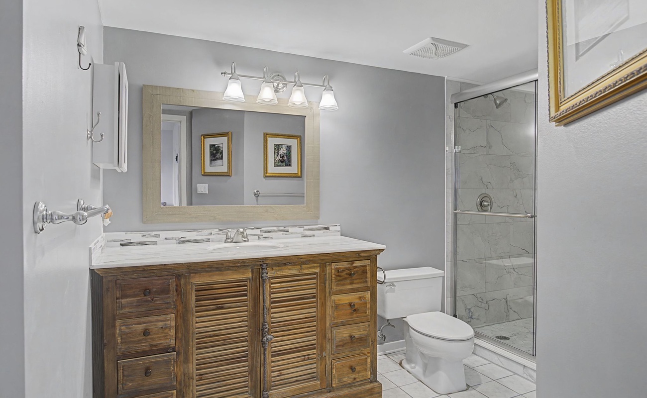 Your private bathroom features marble tile, elegant vanity, and spacious shower for relaxing after adventures.