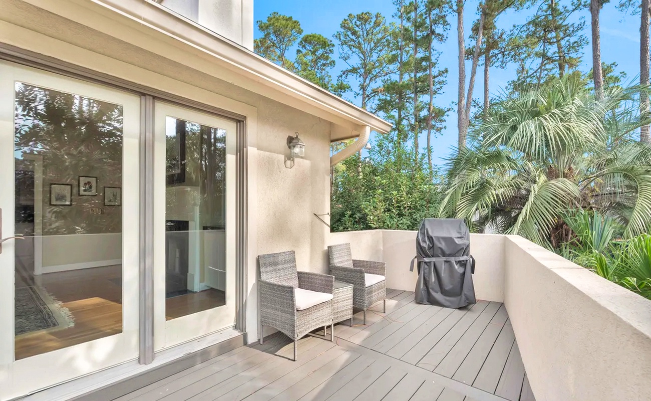 Step onto your private terrace where tropical breezes meet comfortable seating, perfect for morning coffee surrounded by lush greenery.