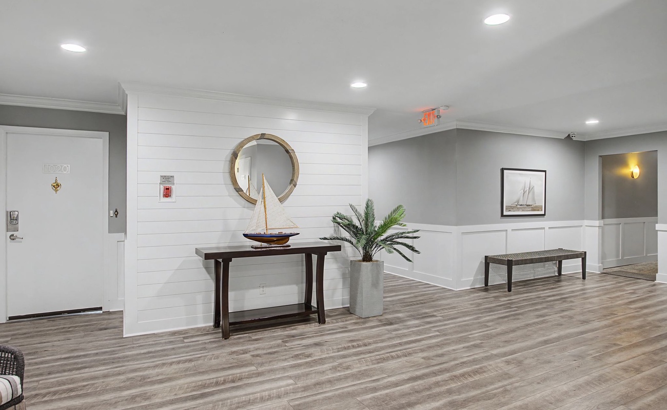 Relax in this elegantly designed common area with coastal-inspired décor, comfortable seating, and warm lighting for your perfect getaway.