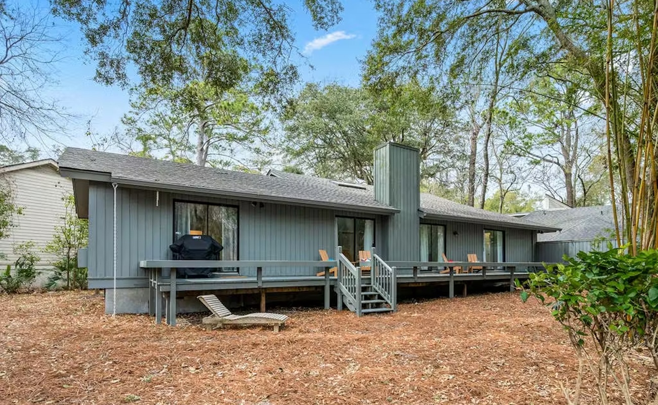 A peaceful retreat surrounded by mature trees and private outdoor space with deck seating and BBQ facilities.