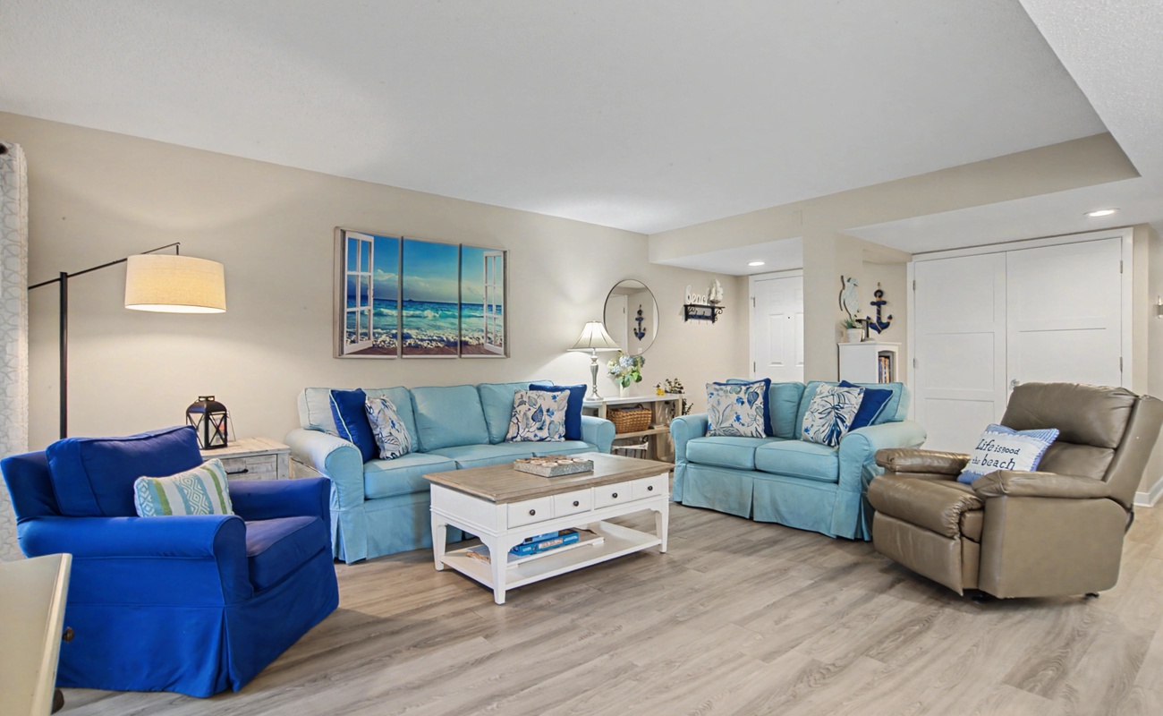 Relax in your coastal living room with ocean blues and comfortable seating for everyone to unwind together.