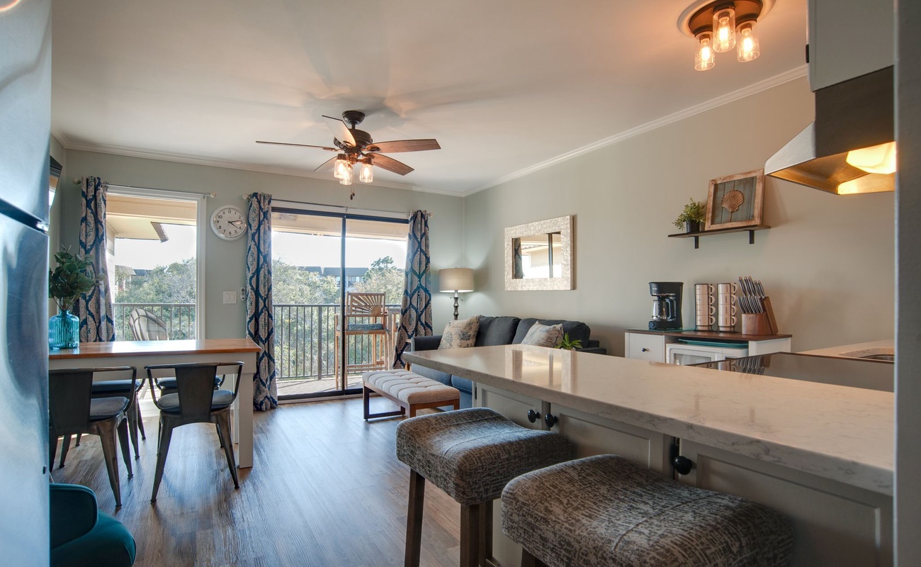 Your open-concept living space features a well-equipped kitchen, comfortable seating, and peaceful views from the private balcony.