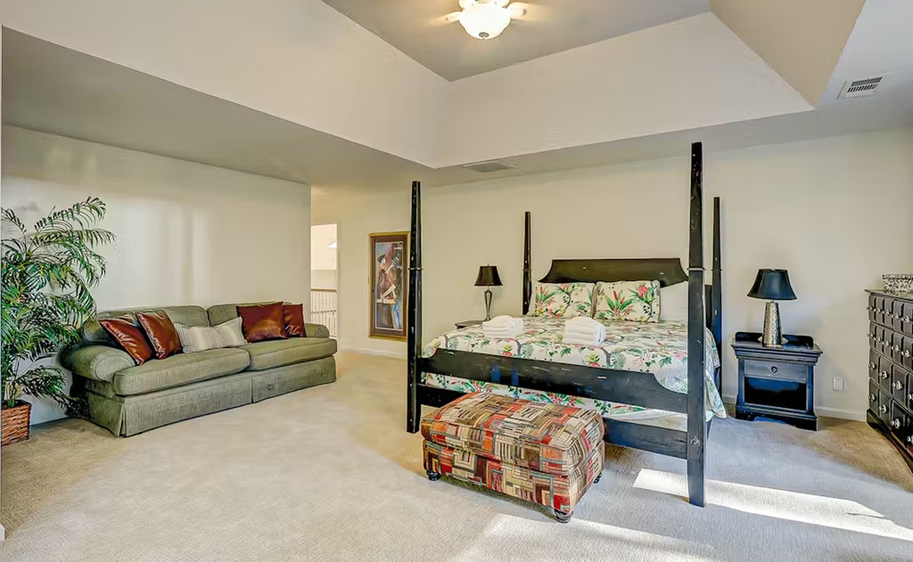 Your spacious suite combines comfort with style, featuring a stunning four-poster bed and cozy seating area for ultimate relaxation.