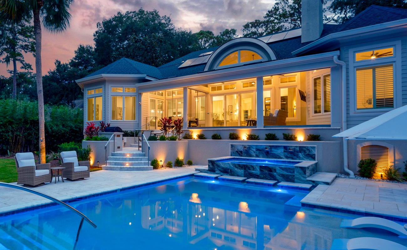 Luxurious Private Backyard with Pool, Ample Seating, and Screened in Porch at Sunset