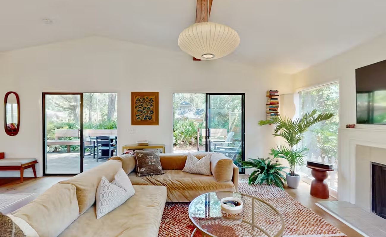 Unwind in your bright, stylish living space with plush seating and lush views through floor-to-ceiling windows.