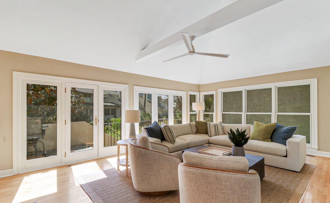 Unwind in your bright, airy living space where floor-to-ceiling windows flood the room with natural light and French doors open to your private outdoor retreat.