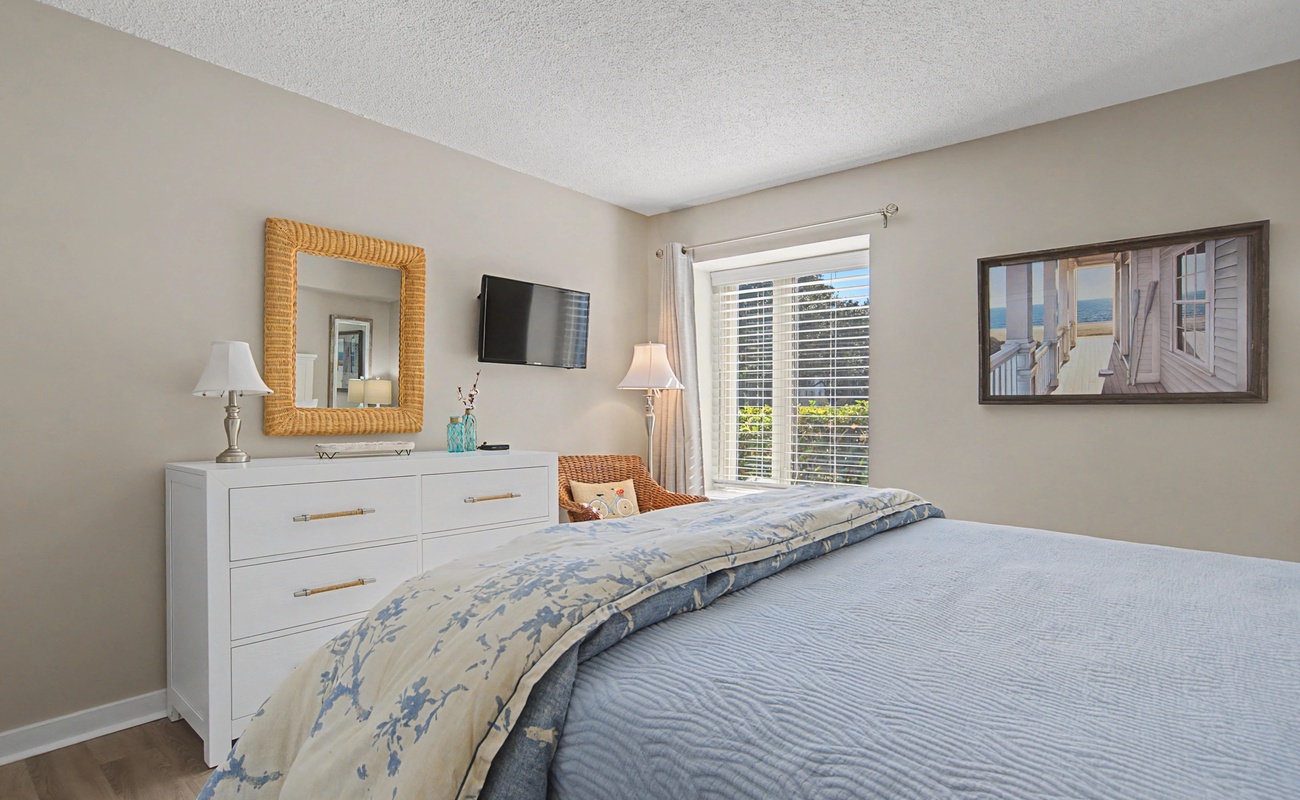 Unwind in your serene bedroom with coastal décor, city views, and crisp linens that promise restful nights.