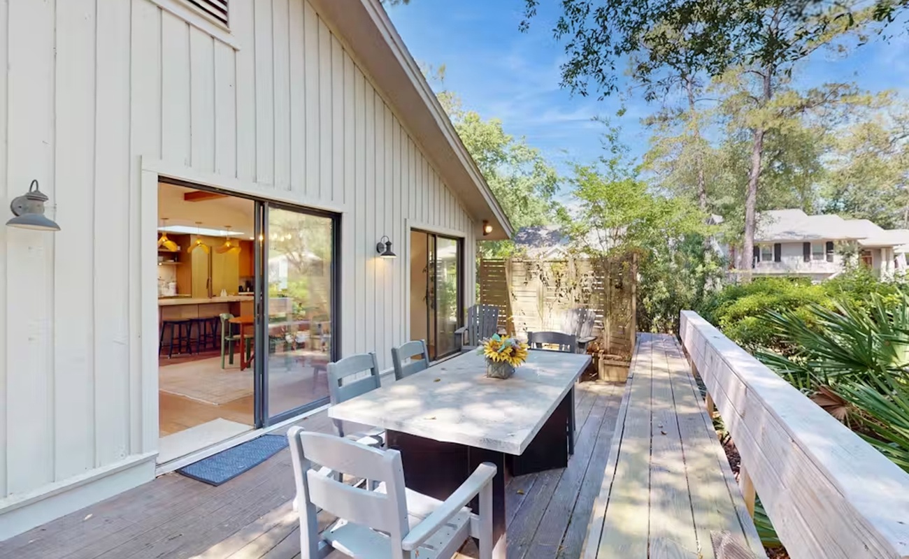 Step onto your private deck where morning coffee and al fresco dinners await at this spacious outdoor table.