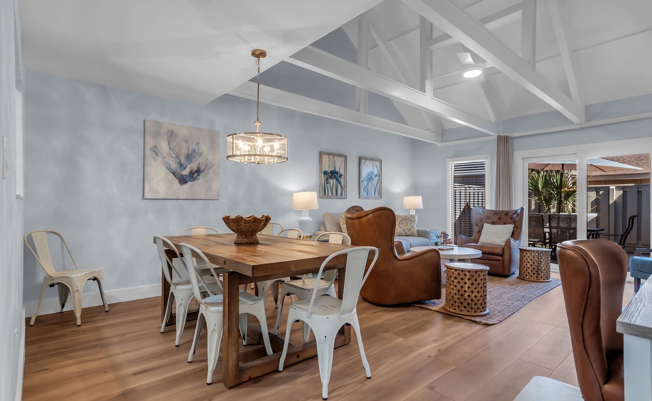 Gather around your spacious open-plan dining and living area, where exposed beams create character above comfortable leather seating and modern dining space.