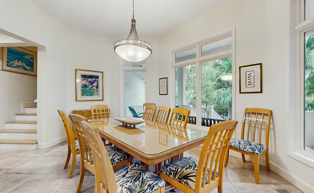 Gather around your elegant dining table where tropical views and thoughtful decor create the perfect setting for memorable meals together.