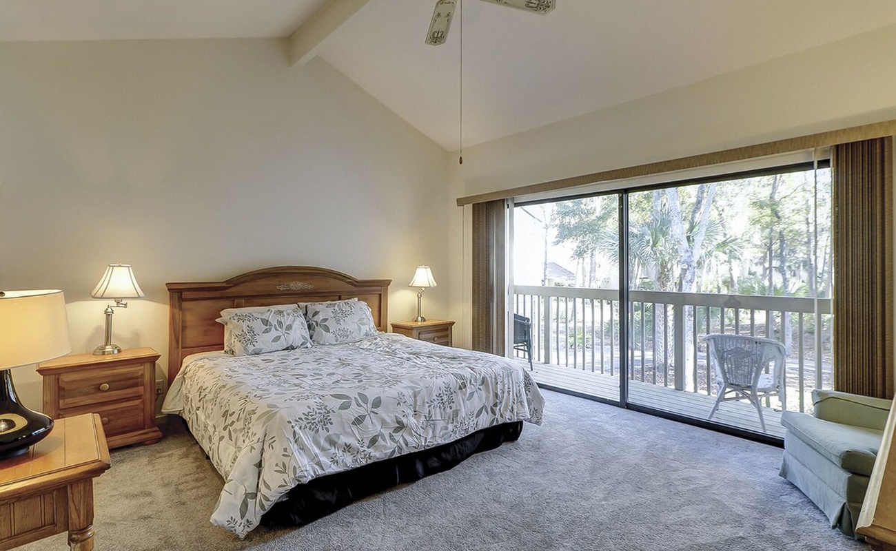 Your master bedroom features vaulted ceilings and a private balcony overlooking lush tropical grounds, creating the perfect retreat for peaceful mornings and restful nights.