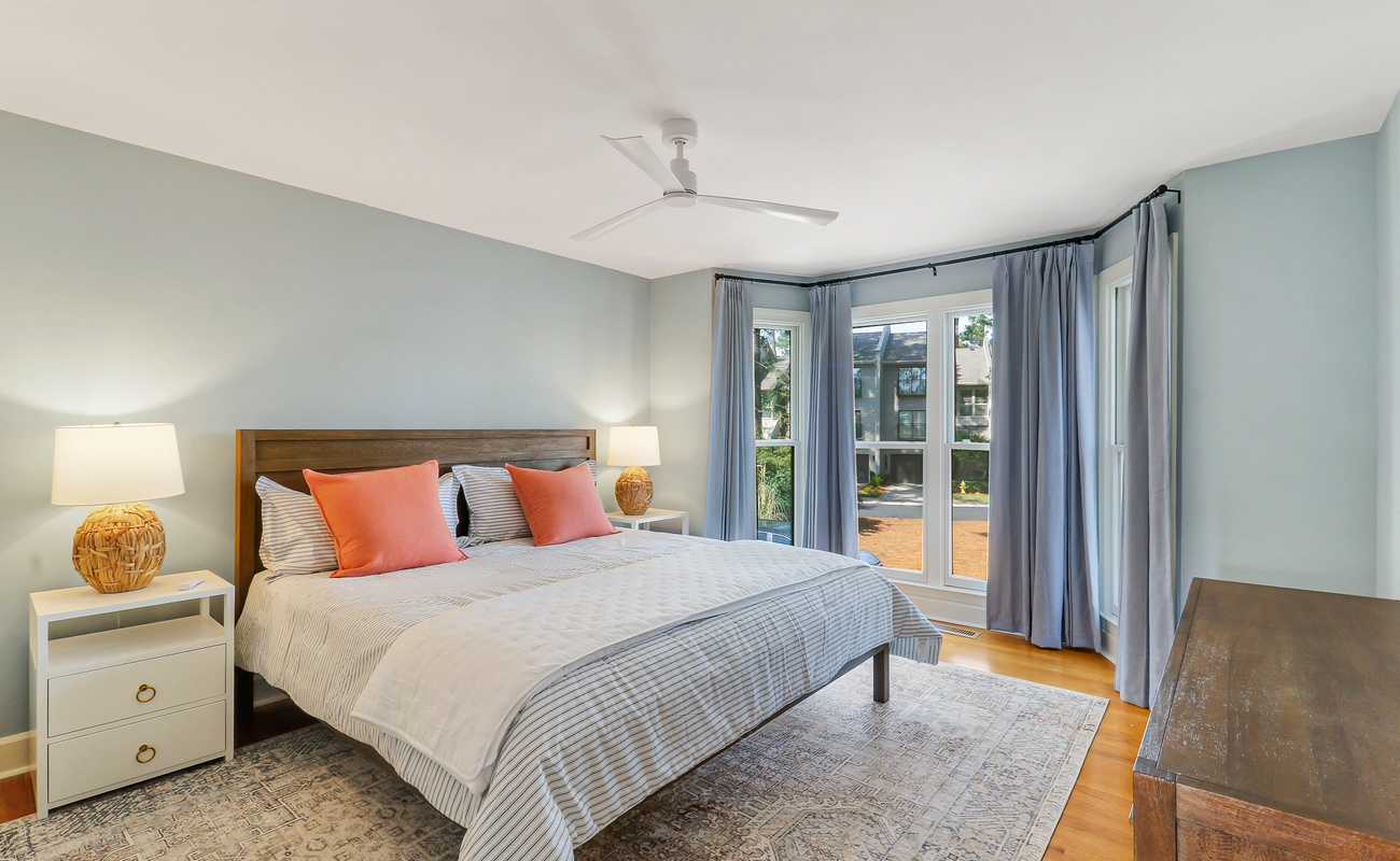 Drift into peaceful sleep in your bright bedroom with coral accents, natural textures, and garden views through floor-to-ceiling windows.