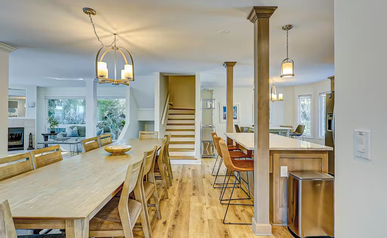 Your spacious open-concept kitchen and dining area flows seamlessly together, perfect for cooking meals and gathering around the large dining table.
