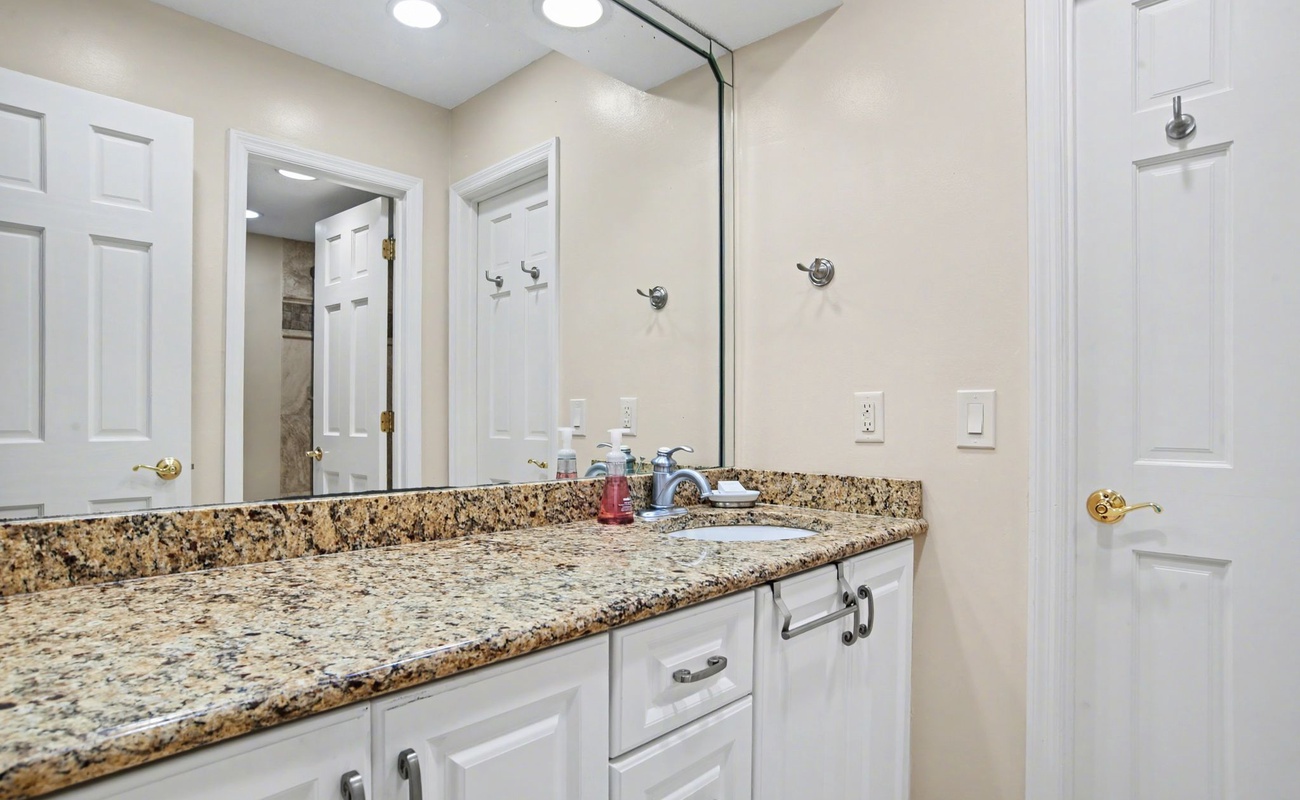 Freshen up in your elegant bathroom featuring granite countertops and modern finishes for a luxurious start to each day.