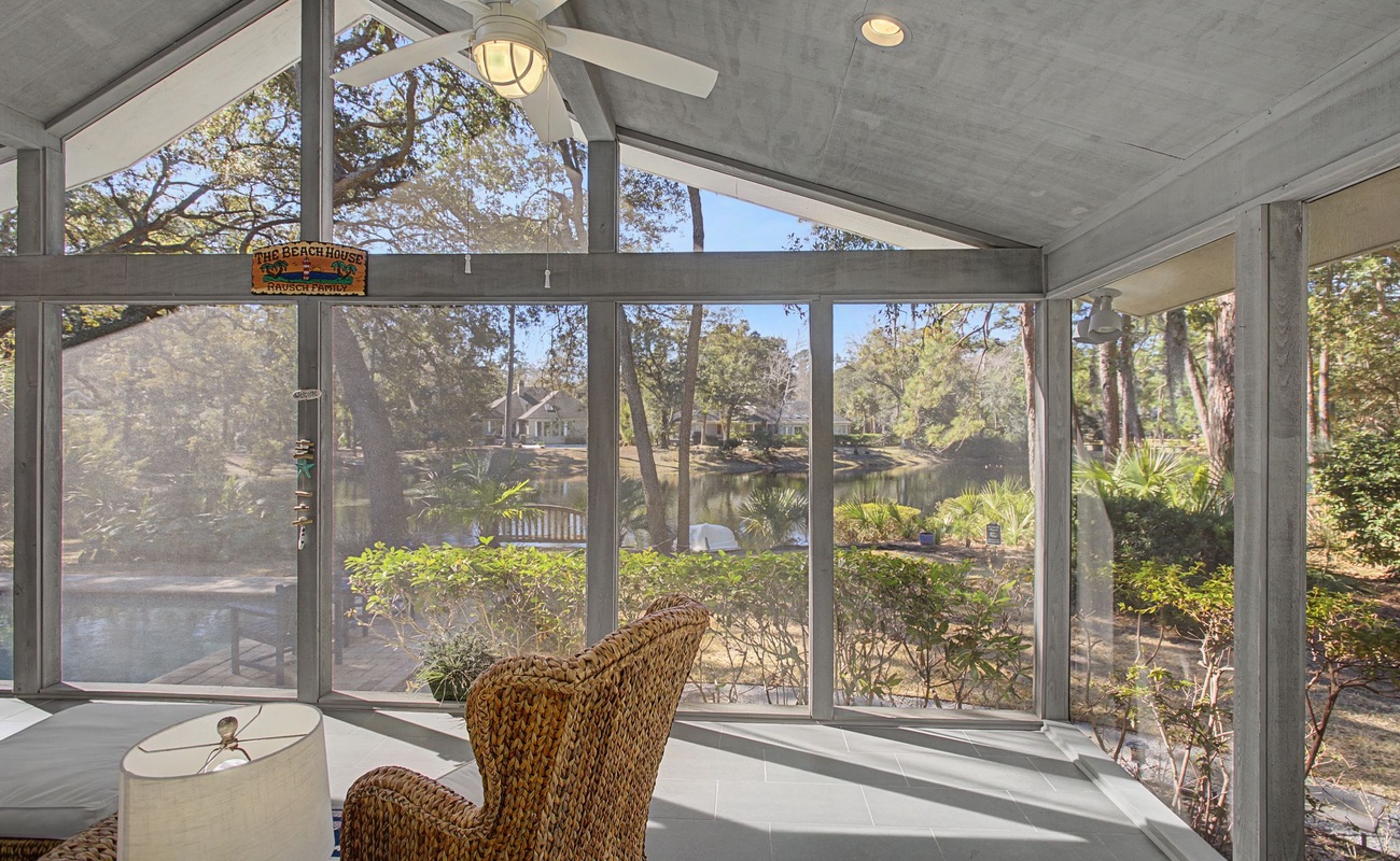 Your bright sunroom offers panoramic garden views through floor-to-ceiling windows, creating a peaceful retreat with natural light.