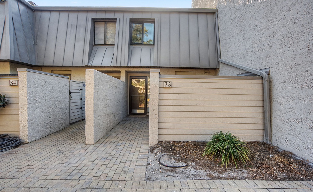 Modern townhouse entrance with convenient parking and private courtyard access for your comfortable stay.