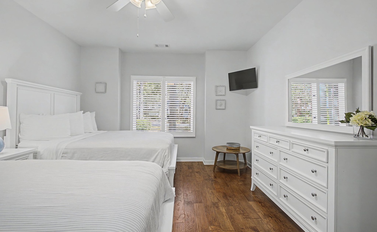 Relax in your peaceful bedroom with two comfortable beds, ample storage, and a mounted TV for your entertainment needs.