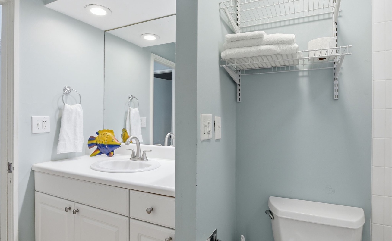 Refresh in your bright, modern bathroom with thoughtful storage and coastal charm—fluffy towels await your arrival.