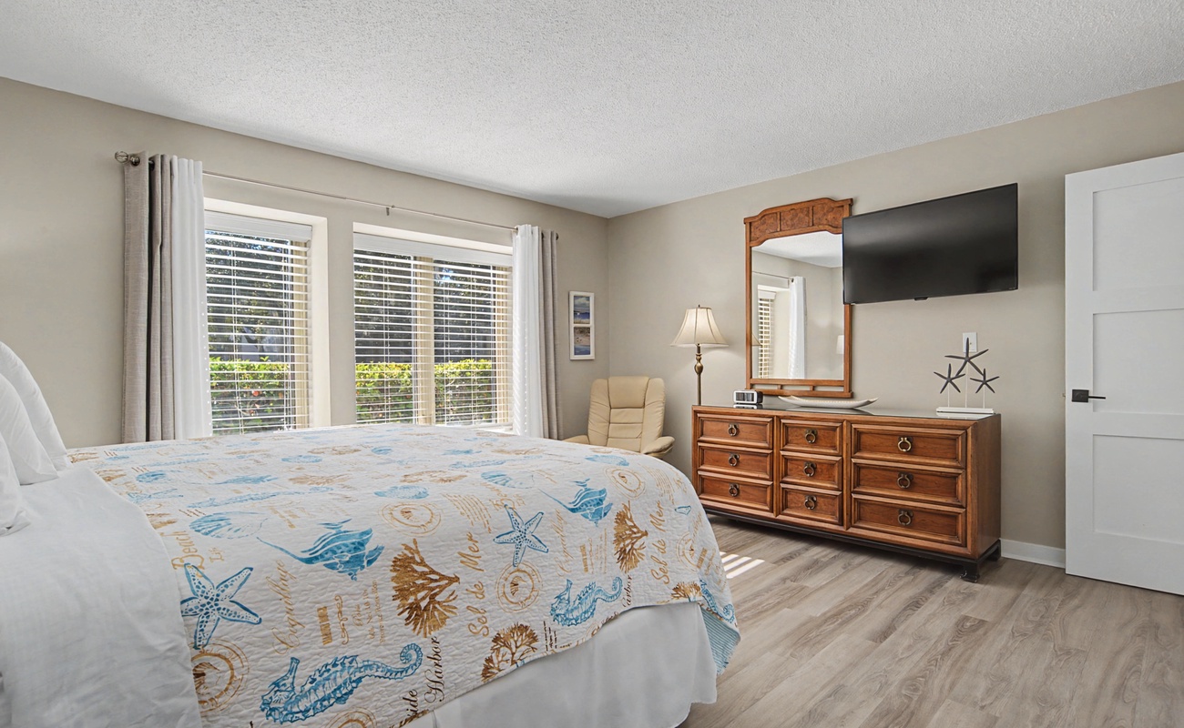 Drift off to sleep in your coastal-themed bedroom, where ocean-inspired decor and warm wood furnishings create the perfect seaside retreat.