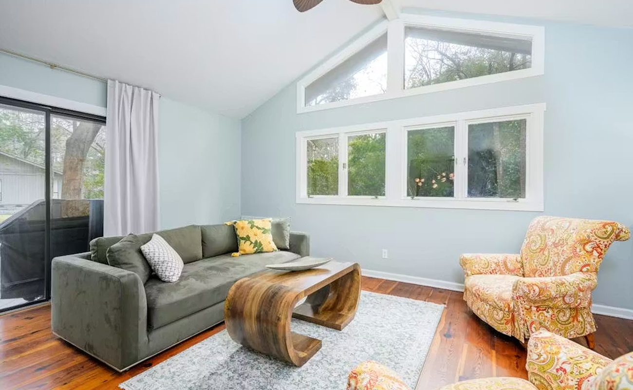 Relax in your bright living space with vaulted ceilings, cozy seating, and garden views through large windows.