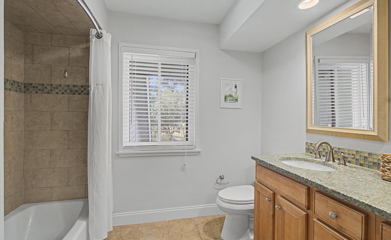 Unwind in your elegant bathroom featuring granite counters, tile shower, and natural light—perfect for your morning routine.