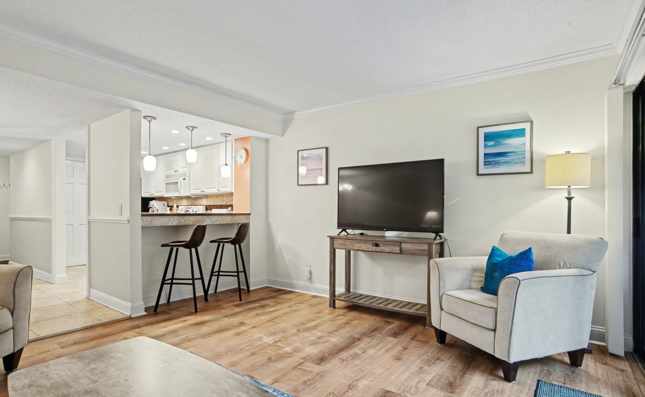 Unwind in your stylish living space with modern furnishings, flatscreen TV, and convenient kitchen bar seating perfect for morning coffee.