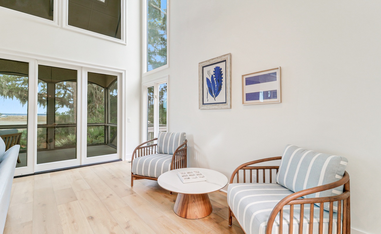 Sink into these cozy striped chairs where natural light streams through soaring windows, creating your perfect reading nook.