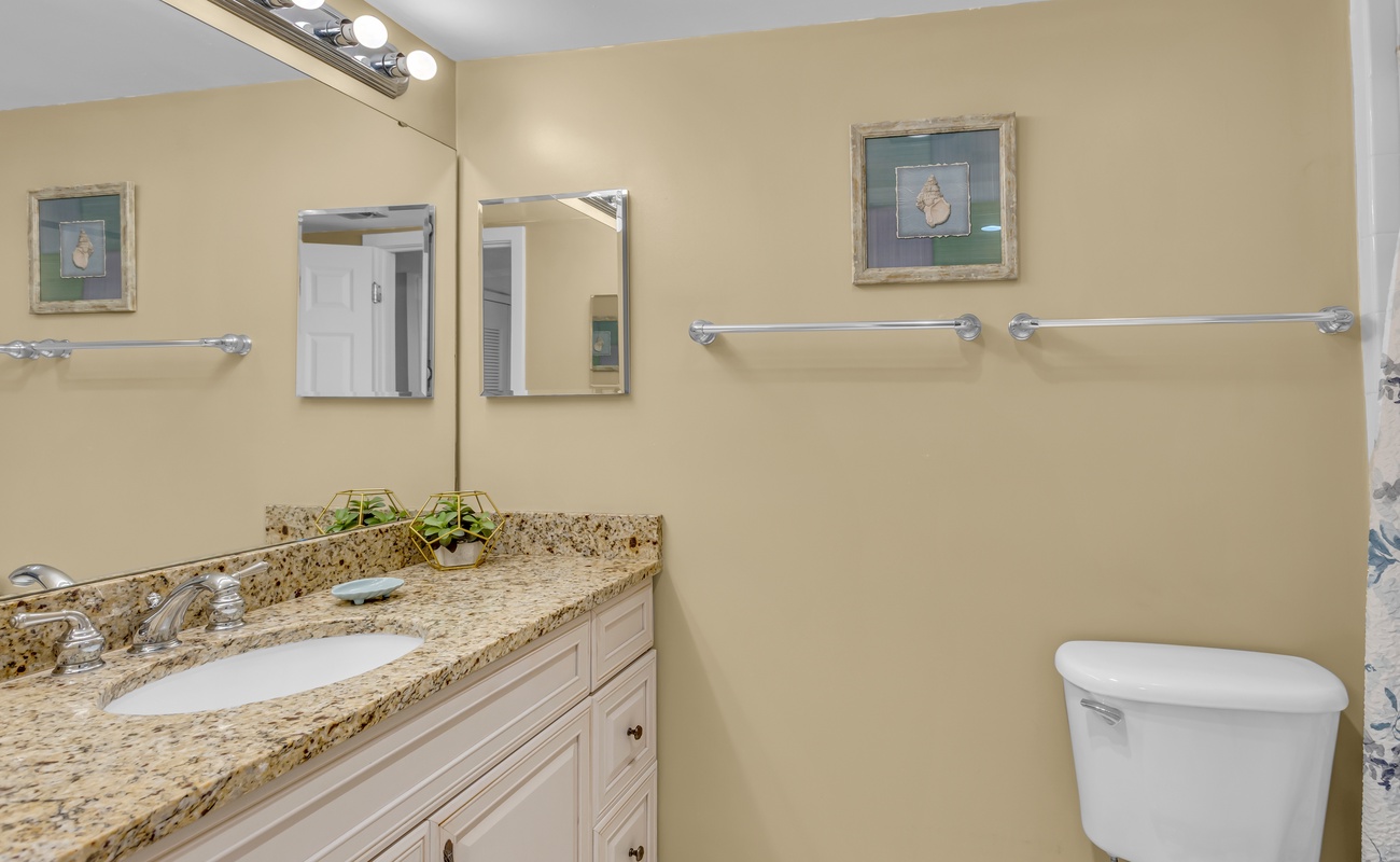 Refresh in your elegant bathroom featuring granite countertops, warm lighting, and thoughtful touches that make your daily routine feel luxurious.