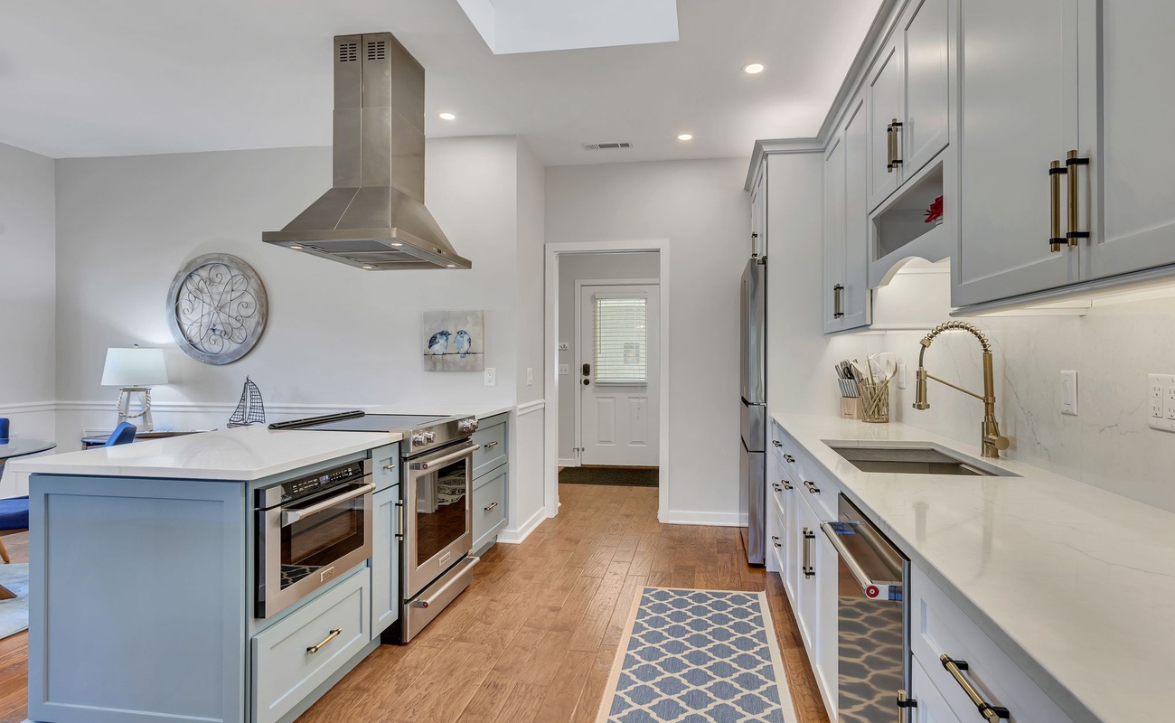 Cook like a chef in your fully equipped gourmet kitchen with gleaming countertops, modern appliances, and elegant coastal-inspired design details.