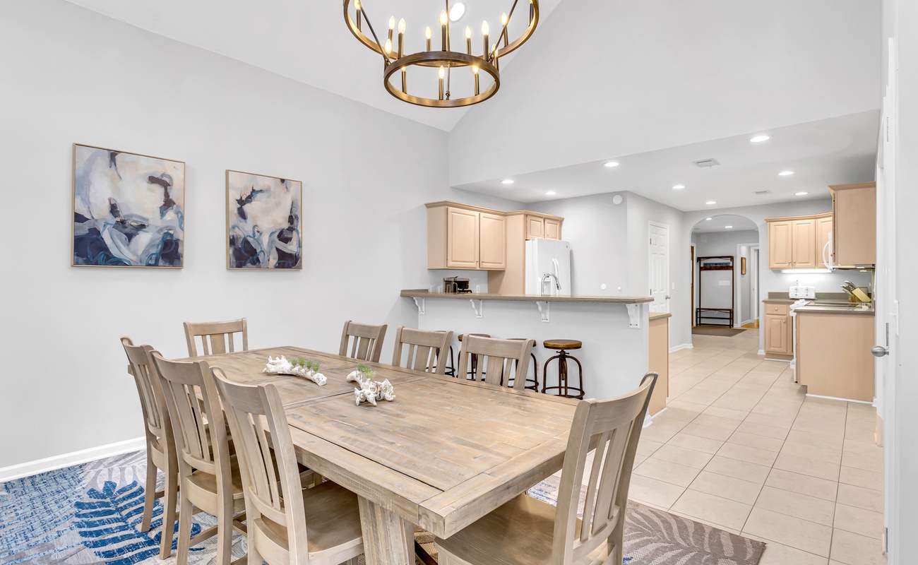 Gather around your spacious dining table where golden light and open kitchen flow create the perfect setting for memorable meals together.