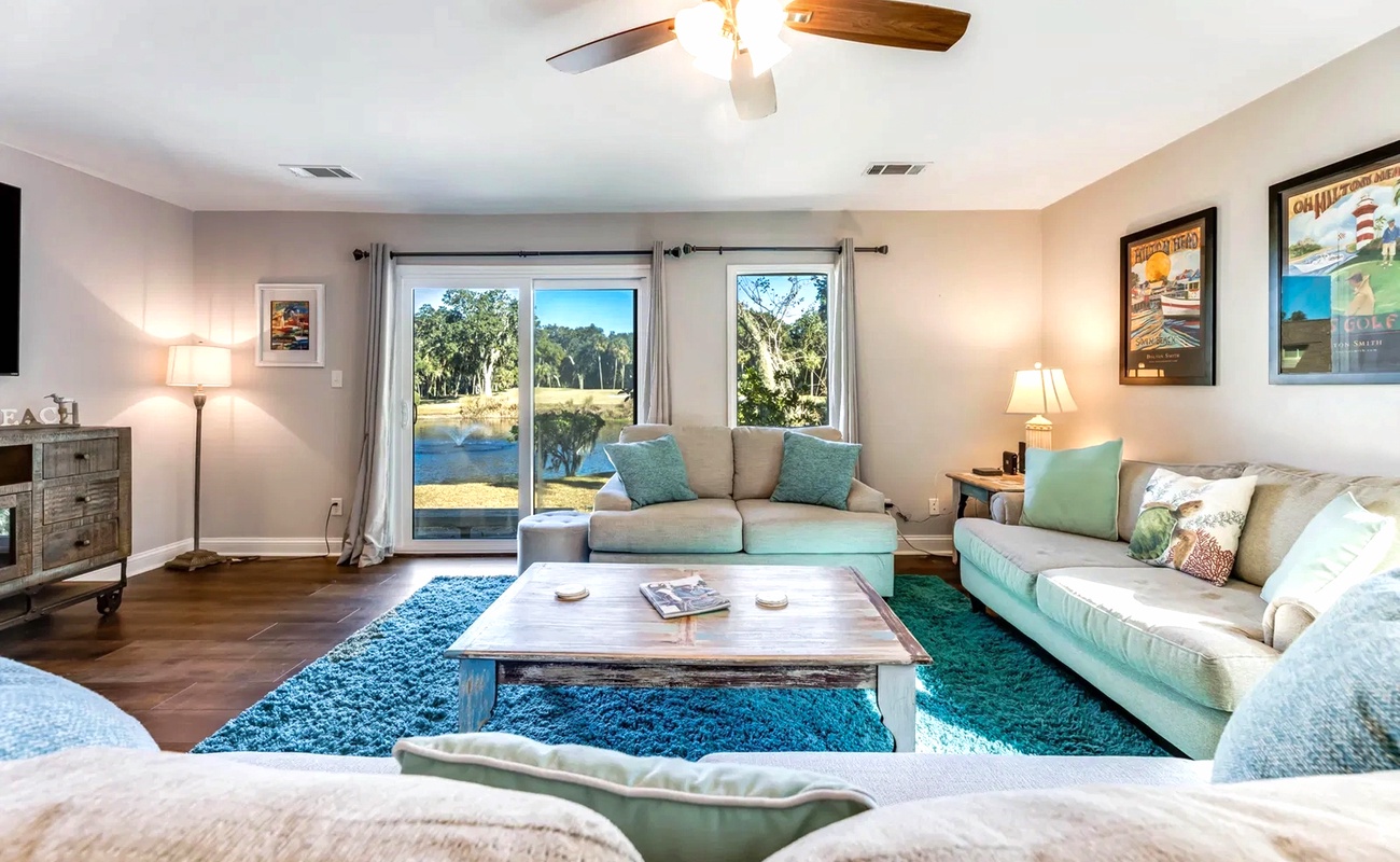 Sink into plush seating with stunning water views flowing through floor-to-ceiling windows, creating your perfect retreat.