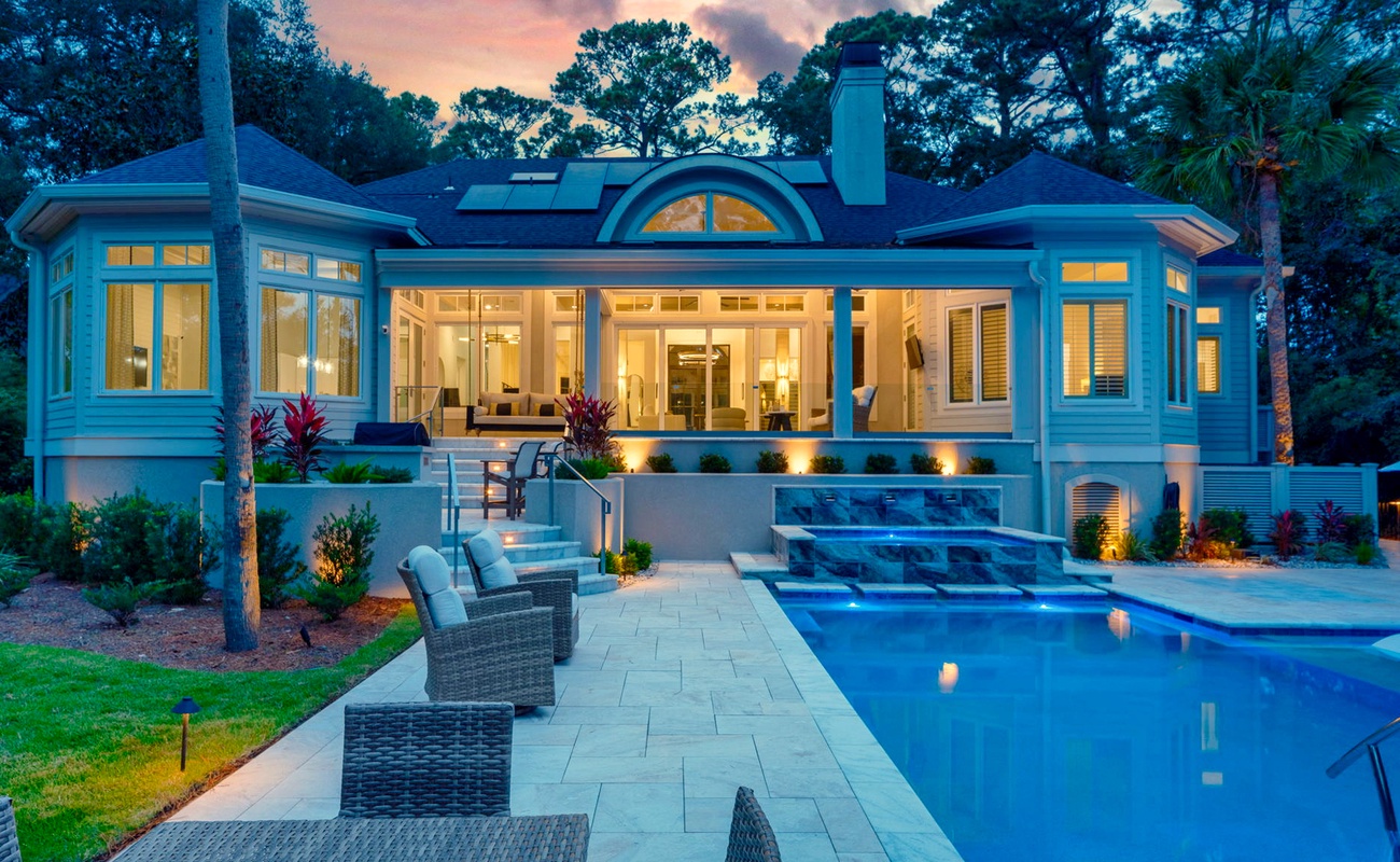 Luxurious Private Backyard with Pool, Ample Seating, and Screened in Porch at Sunset