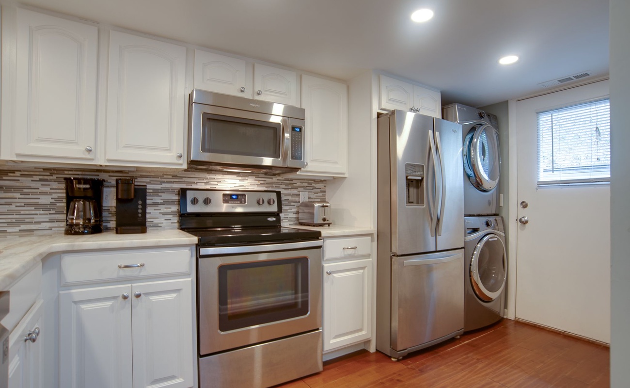 Your bright kitchen comes complete with modern appliances and a convenient washer-dryer combo for extended stays.